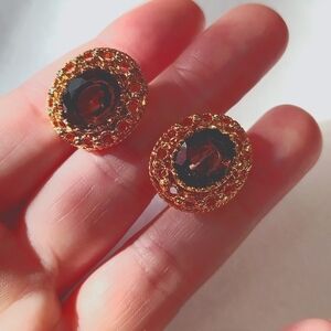 Vintage Gold tone filagree clip on earrings with brown Smoky Rhinestone Centers.
